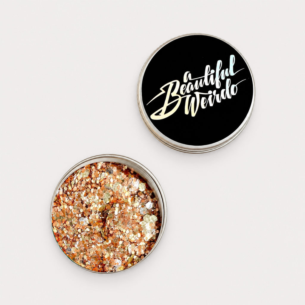 A Beautiful Weirdo Golden Hour Eco Glitter — tin and lid on pale grey