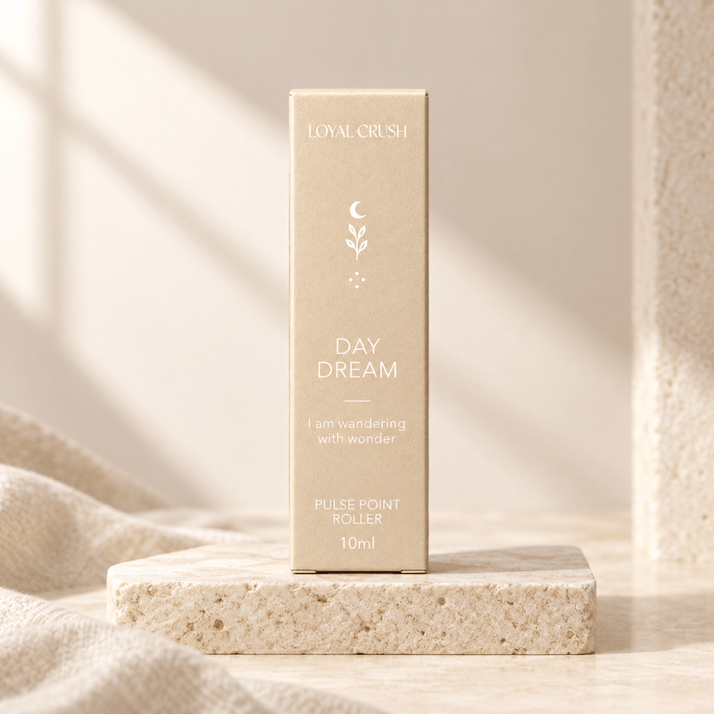Loyal Crush day dream pulse point roller packaging on pale stone