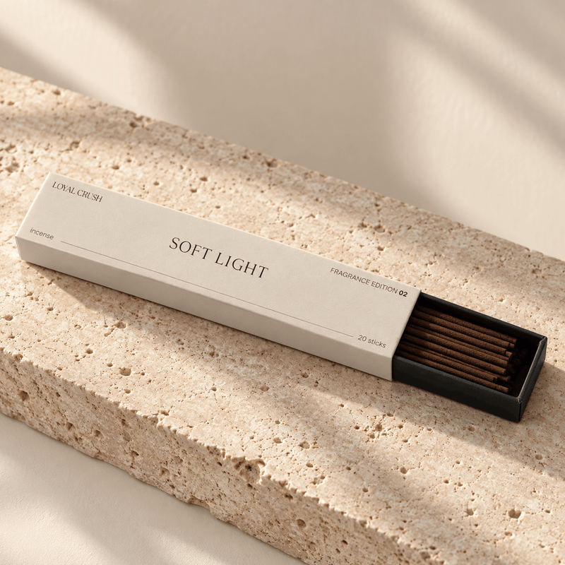 Loyal Crush Soft Light open incense box and sticks on pale stone