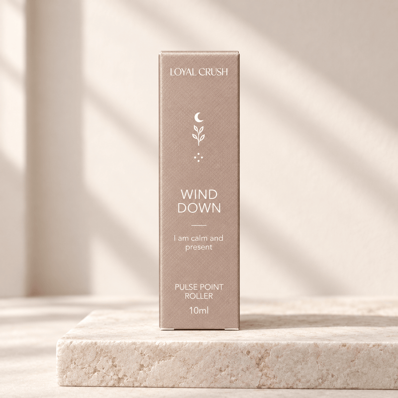 Loyal Crush wind down pulse point roller packaging on pale stone