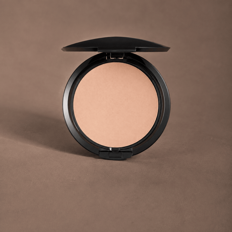 Scout Cosmetics Pressed Powder Foundation on a coloured studio background